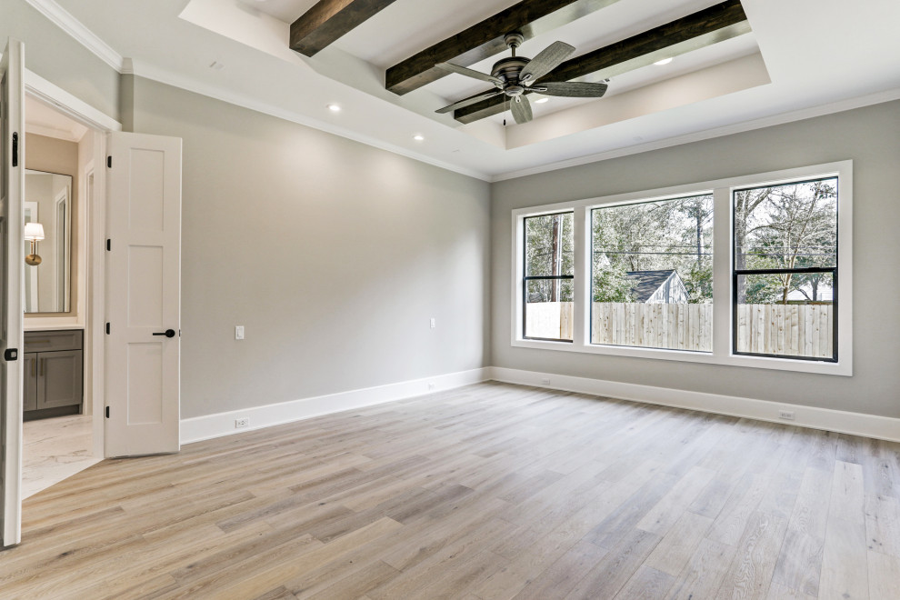 Design ideas for a large classic master bedroom in Houston with grey walls, light hardwood flooring, multi-coloured floors and exposed beams.