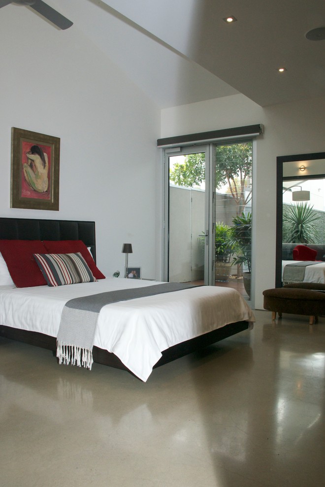 Mid-sized contemporary bedroom in Adelaide with white walls and concrete floors.