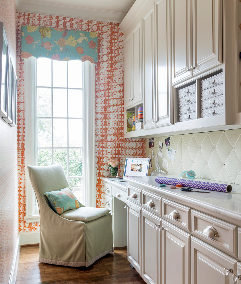 Inspiration for a traditional craft room in Dallas with multi-coloured walls, medium hardwood floors, no fireplace, a built-in desk and brown floor.