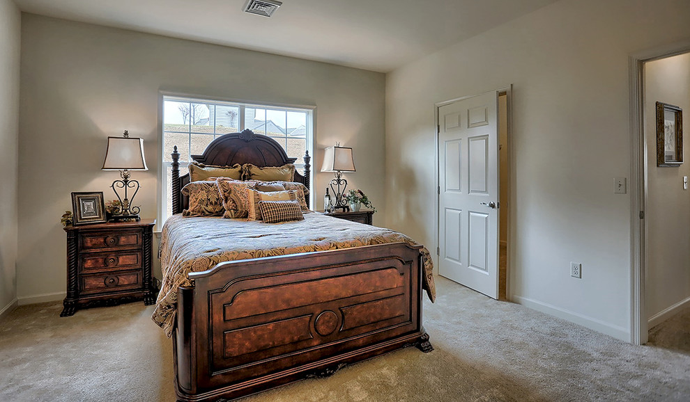 Photo of a large traditional master bedroom in Philadelphia with beige walls, carpet, no fireplace and beige floor.