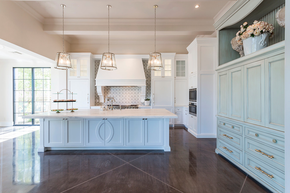 Inspiration for a huge transitional l-shaped dark wood floor and brown floor eat-in kitchen remodel in Phoenix with a farmhouse sink, shaker cabinets, white cabinets, marble countertops, gray backsplash, porcelain backsplash, stainless steel appliances and an island