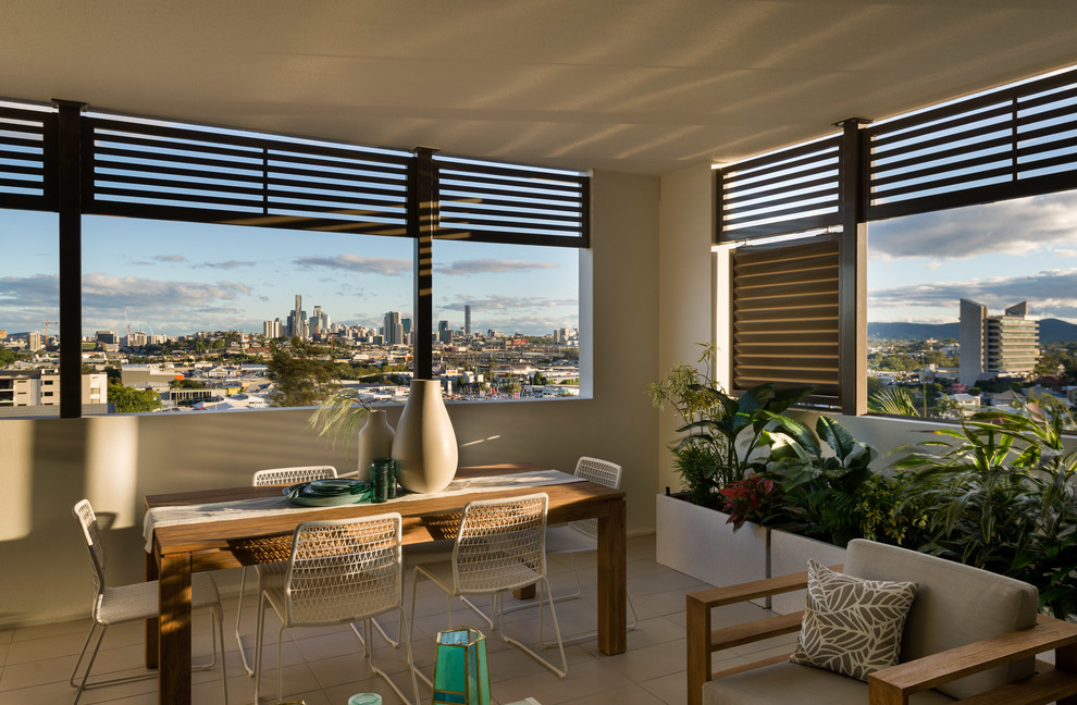 This is an example of a mid-sized transitional sunroom in Brisbane.