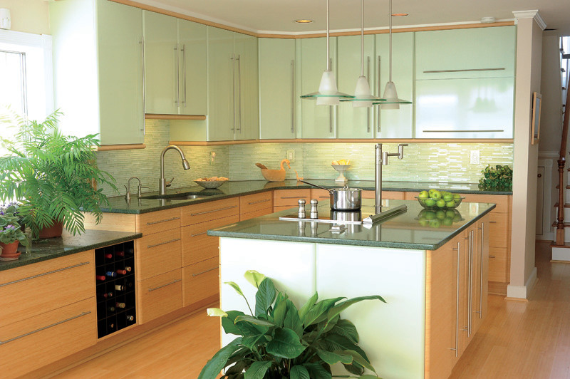 Photo of an expansive modern l-shaped eat-in kitchen in Birmingham with a drop-in sink, glass-front cabinets, green cabinets, granite benchtops, green splashback, glass tile splashback, stainless steel appliances and with island.
