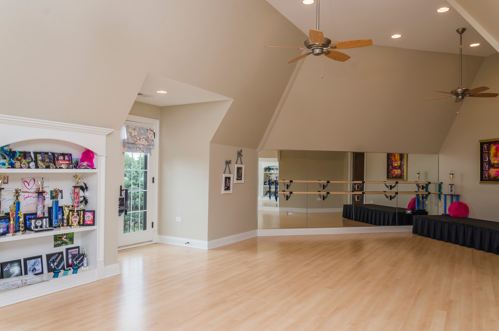 Inspiration for a large traditional home gym in Chicago with beige walls and light hardwood floors.