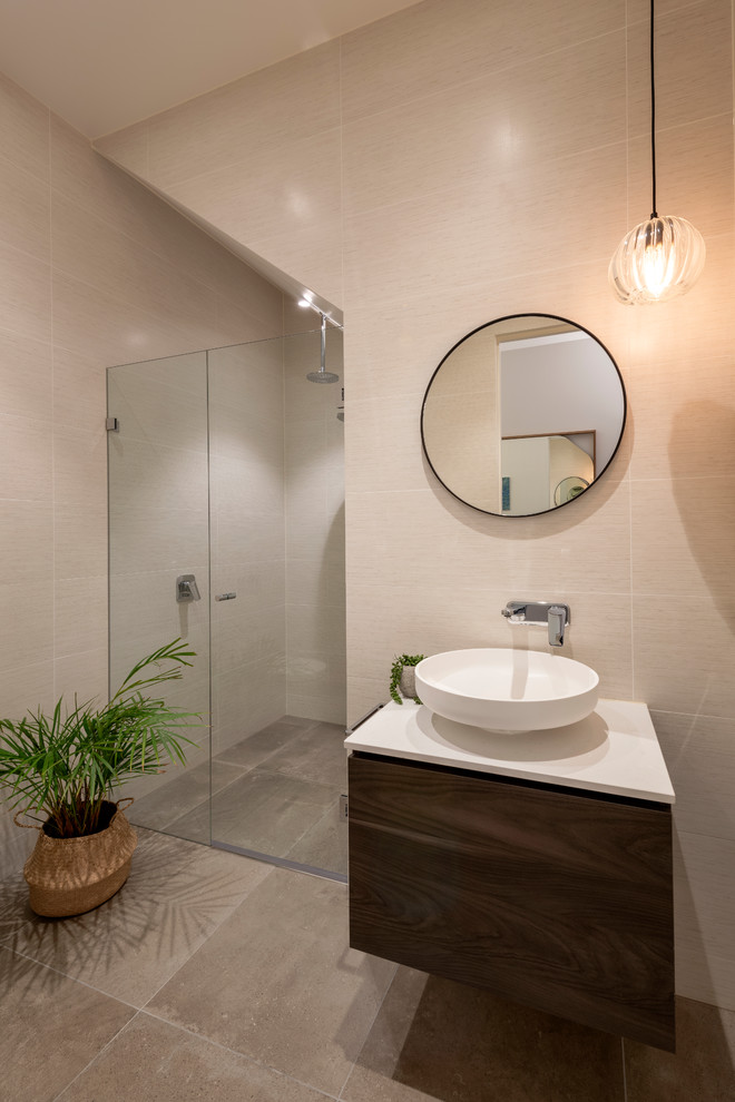 Contemporary 3/4 bathroom in Melbourne with flat-panel cabinets, dark wood cabinets, porcelain tile, porcelain floors, engineered quartz benchtops, brown floor, a hinged shower door, white benchtops, white walls and a console sink.
