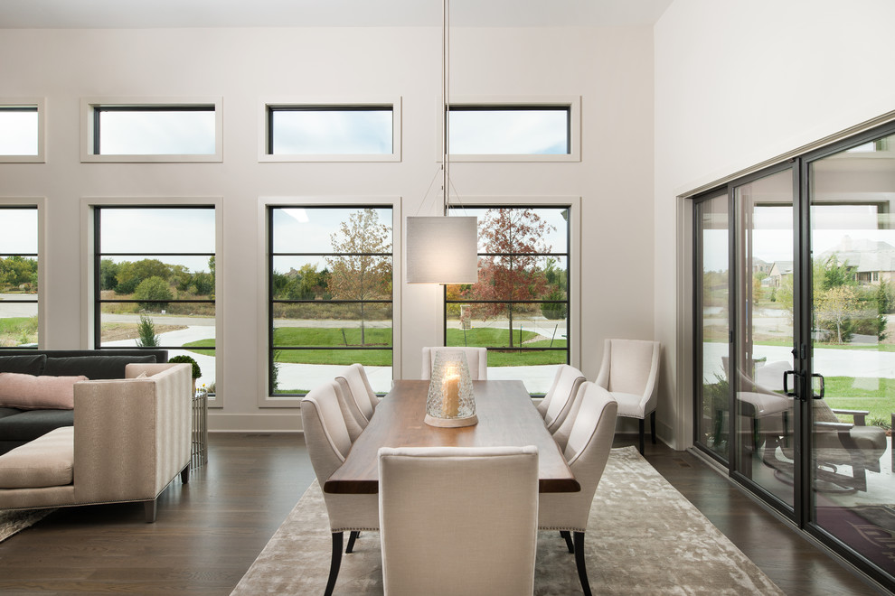 Large contemporary dining room in Wichita with white walls and medium hardwood floors.