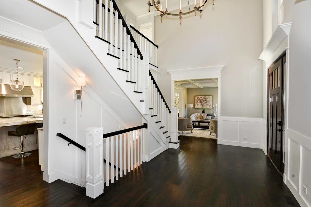 Design ideas for a large transitional wood u-shaped staircase in Chicago with painted wood risers.