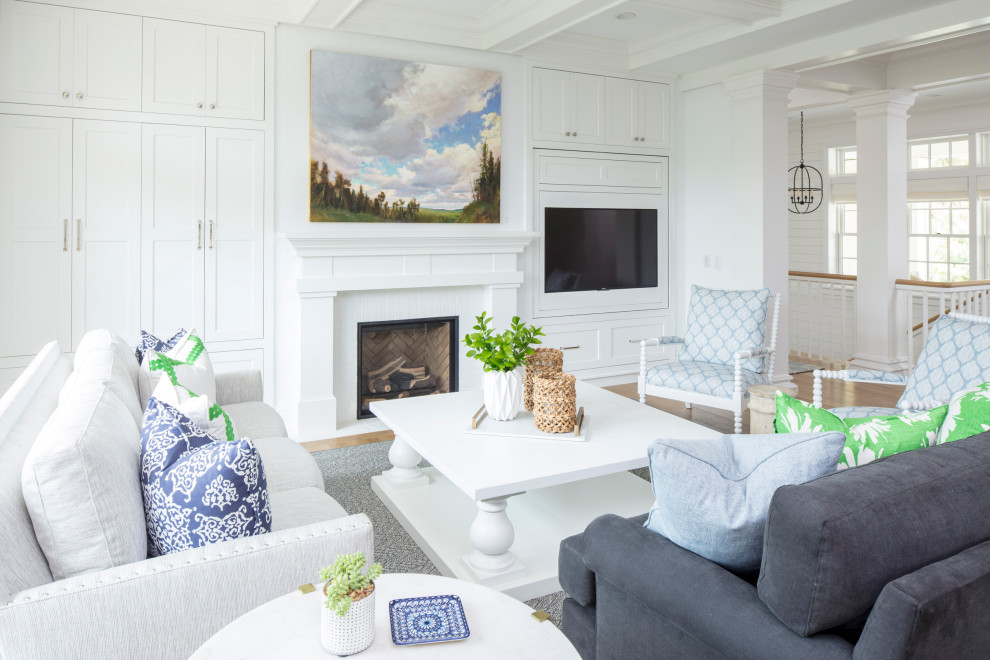 Example of a large transitional formal and open concept medium tone wood floor and brown floor living room design in Minneapolis with white walls, a standard fireplace, a wood fireplace surround and a concealed tv