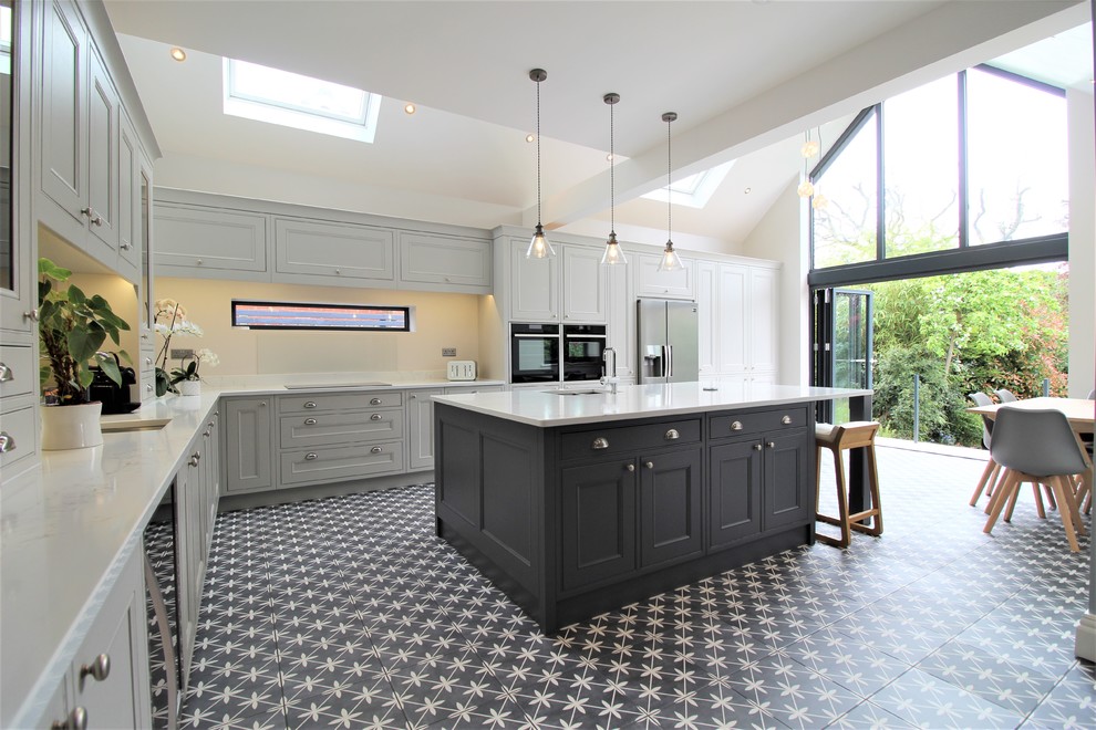 Large transitional l-shaped open plan kitchen in West Midlands with beaded inset cabinets, grey cabinets, quartzite benchtops, with island and white benchtop.