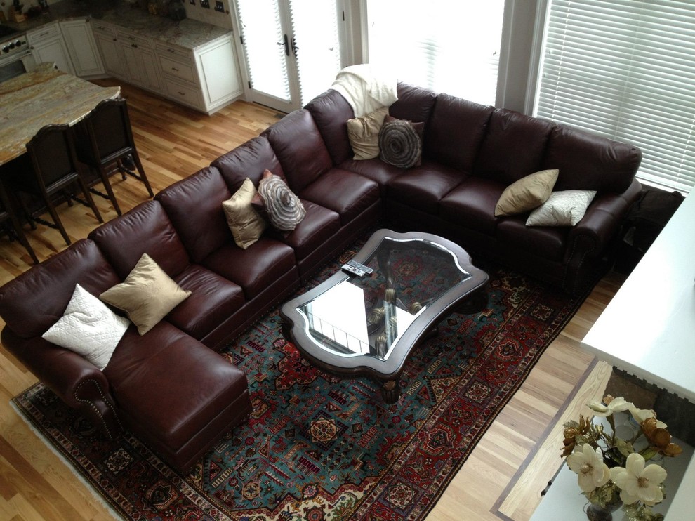 Example of a huge classic light wood floor family room design in New York with gray walls, a standard fireplace, a stone fireplace and a wall-mounted tv