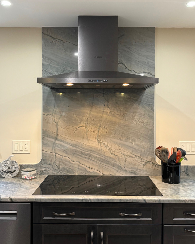 Eat-in kitchen - mid-sized transitional u-shaped laminate floor and brown floor eat-in kitchen idea in Boston with an undermount sink, shaker cabinets, brown cabinets, quartz countertops, black appliances, an island and multicolored countertops