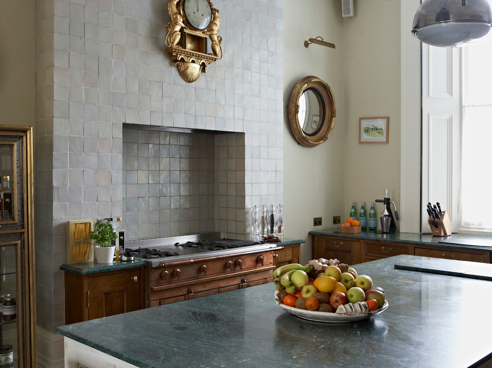 Inspiration for a traditional kitchen in London with with island.
