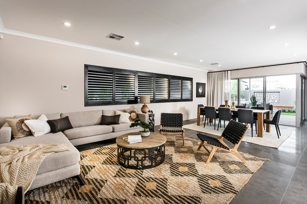 This is an example of a contemporary formal open concept living room in Perth with ceramic floors and beige walls.