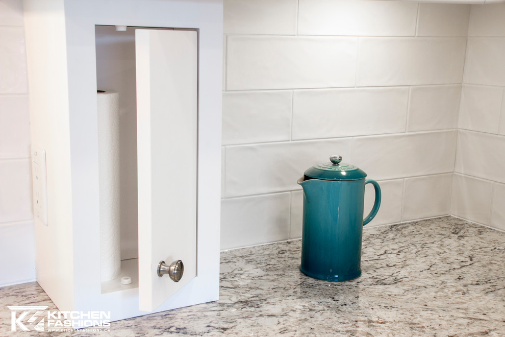Inspiration for a large transitional u-shaped light wood floor home design remodel with a farmhouse sink, shaker cabinets, white cabinets, granite countertops, white backsplash, subway tile backsplash, stainless steel appliances and no island
