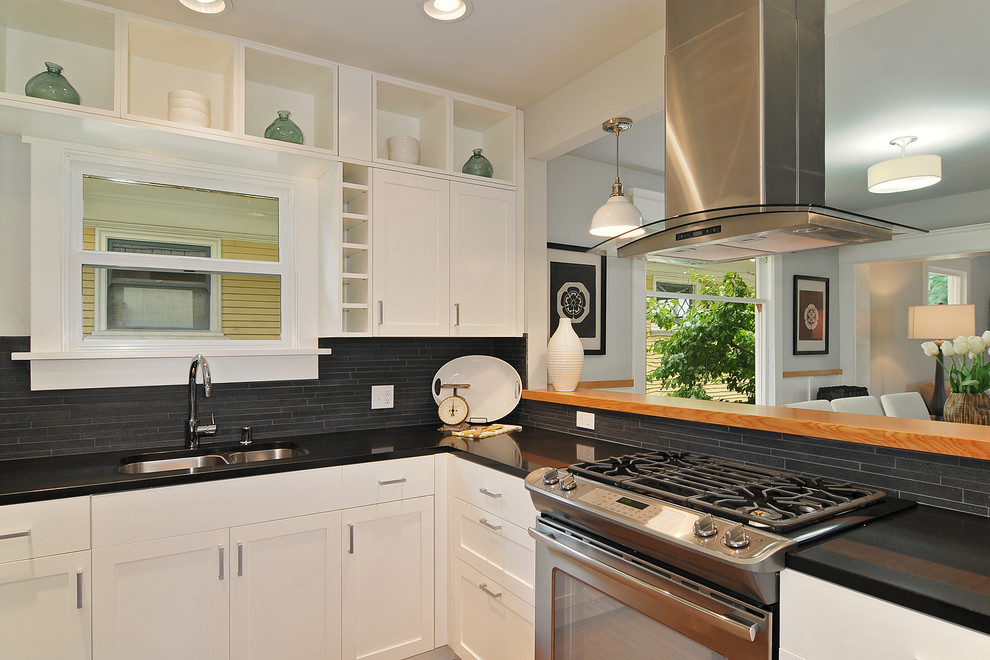 Photo of a contemporary open plan kitchen in Seattle with an undermount sink, white cabinets, grey splashback, matchstick tile splashback, stainless steel appliances and recessed-panel cabinets.