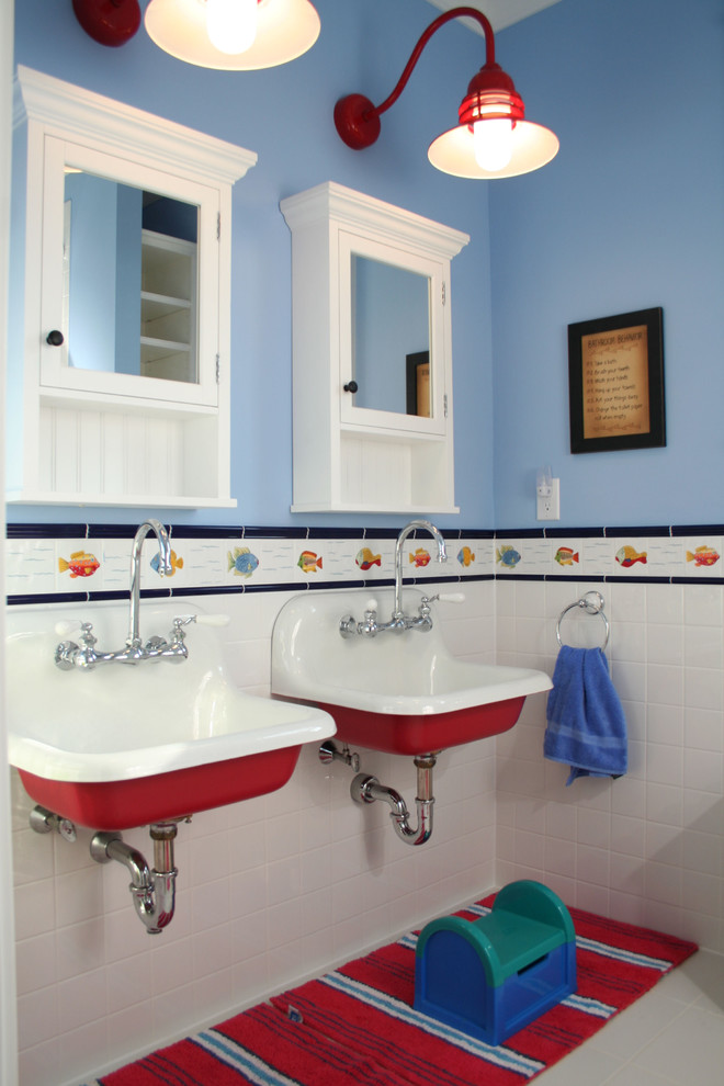 Eclectic kids bathroom in Charleston with a wall-mount sink and blue walls.