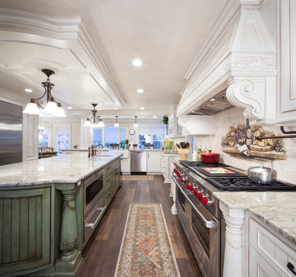 This is an example of a traditional kitchen in New York with an undermount sink, white cabinets, beige splashback, stainless steel appliances, medium hardwood floors, with island and beaded inset cabinets.