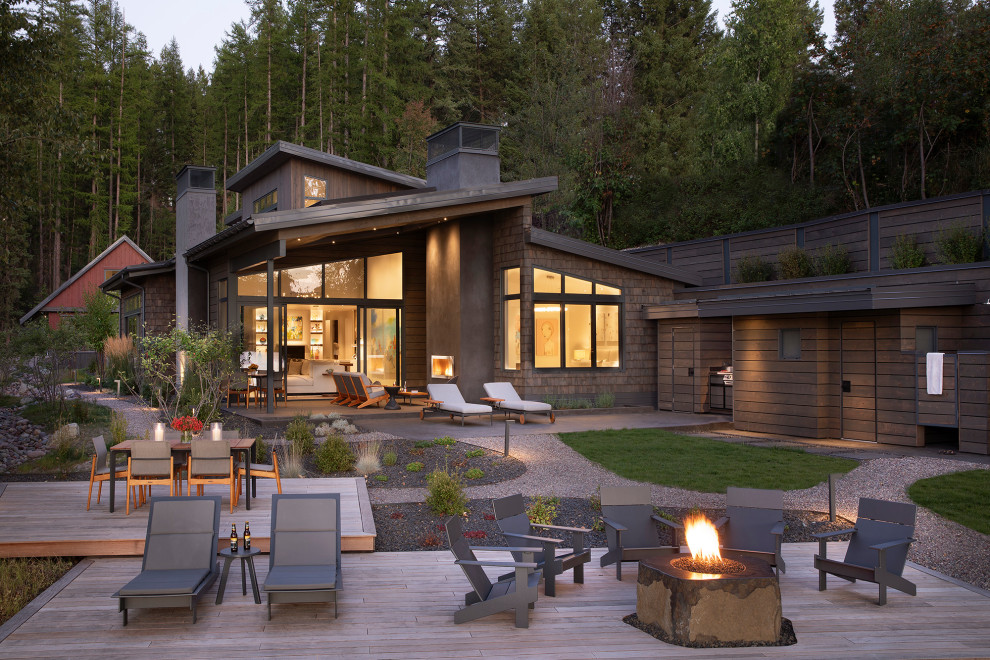 This is an example of a contemporary deck in Other with a fire feature and no cover.