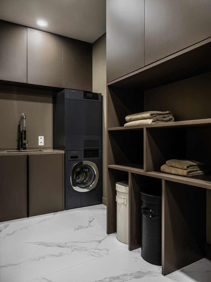 Trendy dedicated laundry room photo in Moscow with an undermount sink, flat-panel cabinets, beige cabinets, beige backsplash, beige walls, a stacked washer/dryer and beige countertops