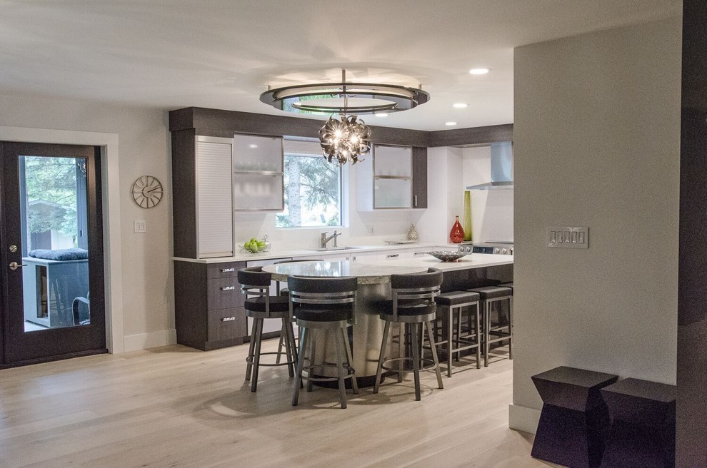 Photo of a large contemporary l-shaped eat-in kitchen in Other with a double-bowl sink, flat-panel cabinets, white cabinets, quartzite benchtops, white splashback, mosaic tile splashback, stainless steel appliances, porcelain floors and with island.