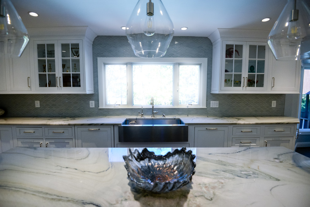 Inspiration for a large transitional u-shaped eat-in kitchen remodel in DC Metro with a farmhouse sink, recessed-panel cabinets, white cabinets, marble countertops, stainless steel appliances, an island, gray backsplash and porcelain backsplash