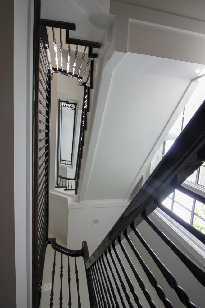 Inspiration for a large transitional wooden l-shaped mixed material railing staircase remodel in DC Metro with painted risers