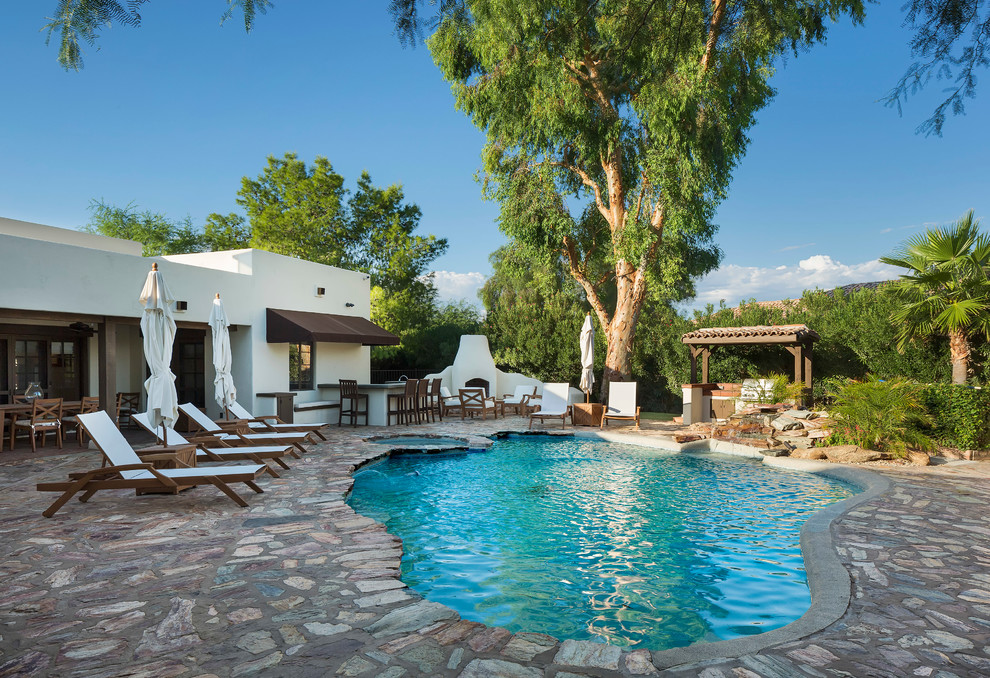 Design ideas for a backyard custom-shaped pool in Phoenix.