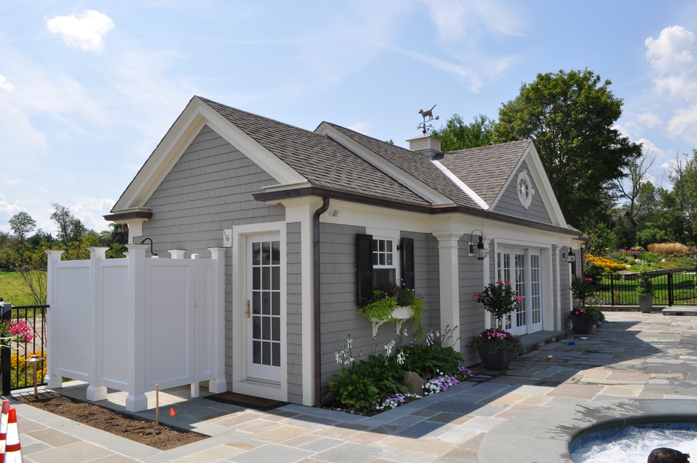 Photo of a mid-sized traditional one-storey grey house exterior in Boston with wood siding, a gable roof and a shingle roof.