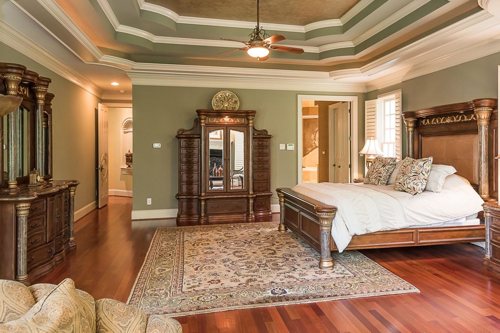 Inspiration for a large traditional master bedroom in Raleigh with green walls, dark hardwood floors, no fireplace and brown floor.