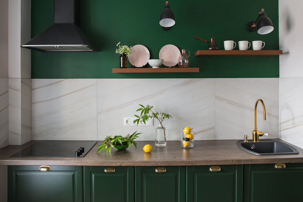 Inspiration for a small traditional l-shaped eat-in kitchen in Saint Petersburg with a drop-in sink, recessed-panel cabinets, green cabinets, laminate benchtops, beige splashback, porcelain splashback, black appliances, vinyl floors, no island, brown floor and brown benchtop.