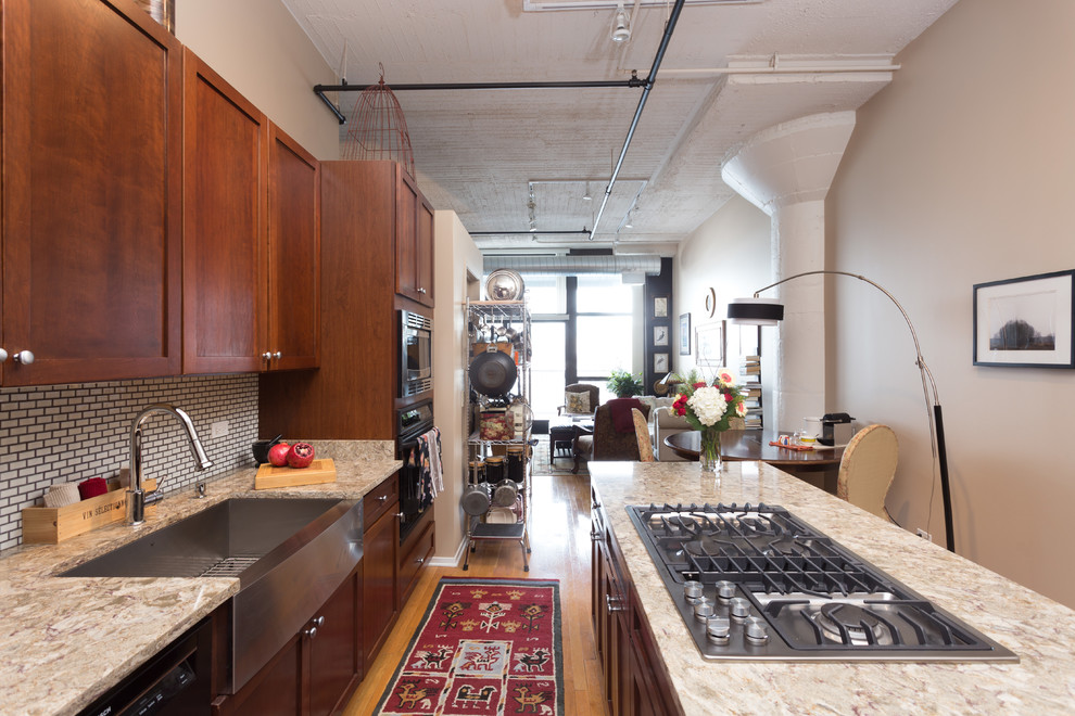 Example of a mid-sized trendy galley medium tone wood floor enclosed kitchen design in Chicago with an undermount sink, flat-panel cabinets, medium tone wood cabinets, granite countertops, white backsplash, cement tile backsplash, stainless steel appliances and an island