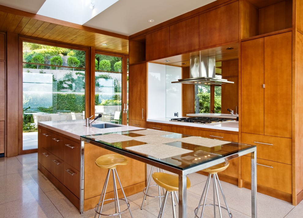 Contemporary kitchen in San Francisco with with island, a single-bowl sink, flat-panel cabinets and medium wood cabinets.