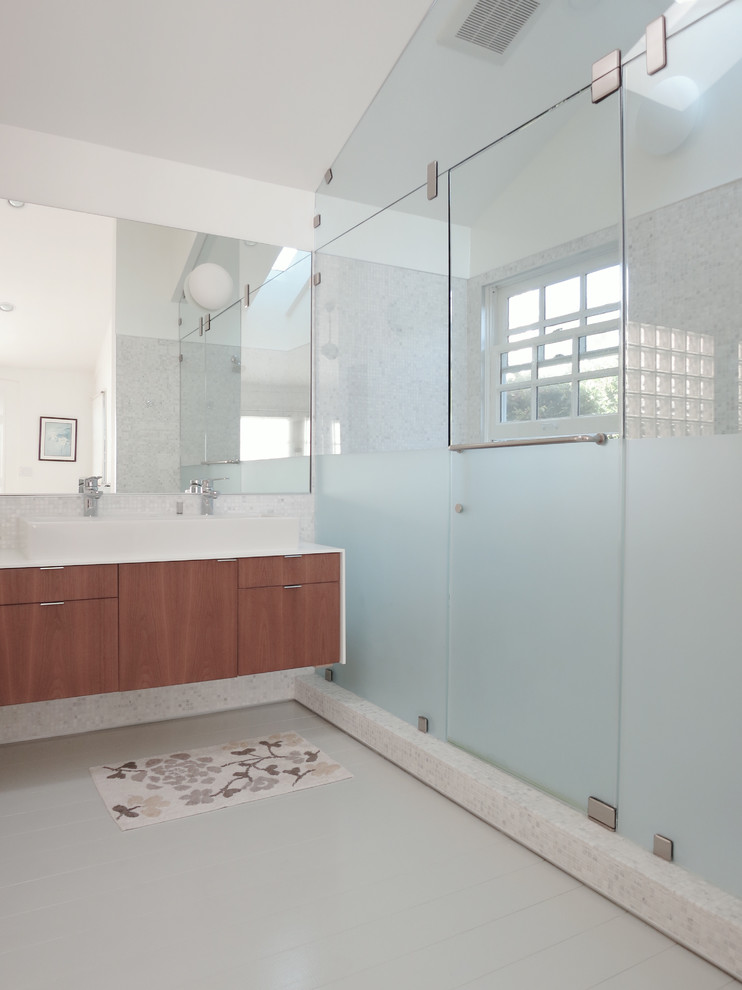 This is an example of a large modern master bathroom in Los Angeles with flat-panel cabinets, medium wood cabinets, a double shower, white walls, a trough sink and a hinged shower door.
