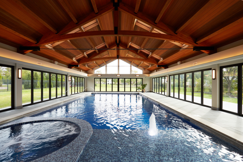 Design ideas for an expansive transitional indoor rectangular pool in Chicago with a hot tub.