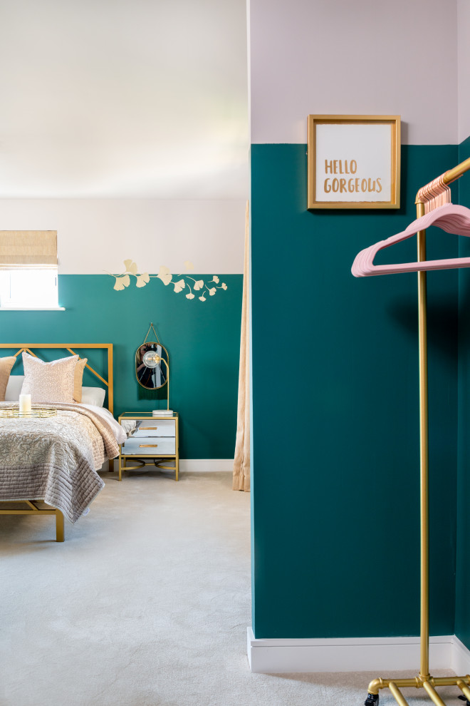 Photo of a mid-sized eclectic guest bedroom in Oxfordshire with green walls, carpet and beige floor.
