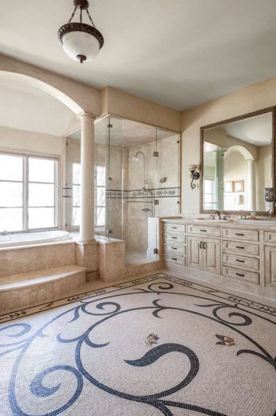 Design ideas for a transitional master bathroom in Dallas with mosaic tile floors, raised-panel cabinets, white cabinets, a drop-in tub, a corner shower, beige tile, beige walls and a drop-in sink.