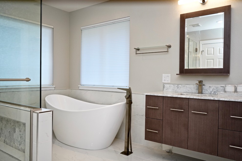 Design ideas for a large modern master bathroom in Seattle with a freestanding tub, white tile, white walls, marble benchtops, a hinged shower door, recessed-panel cabinets, medium wood cabinets, ceramic tile, ceramic floors and grey benchtops.