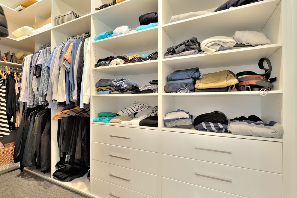 Photo of a mid-sized traditional gender-neutral walk-in wardrobe in Perth with flat-panel cabinets, white cabinets, carpet and grey floor.