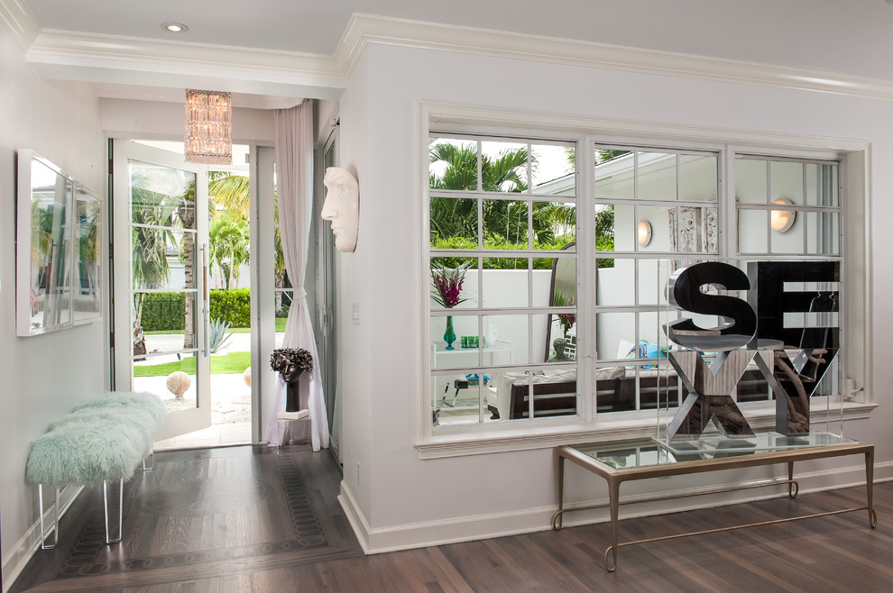 Design ideas for a contemporary entryway in Miami with a glass front door.