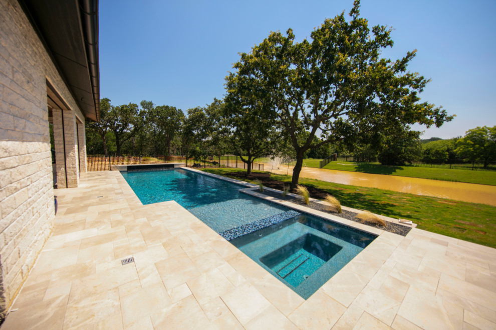 Pool - huge transitional two-story white pool idea in Dallas