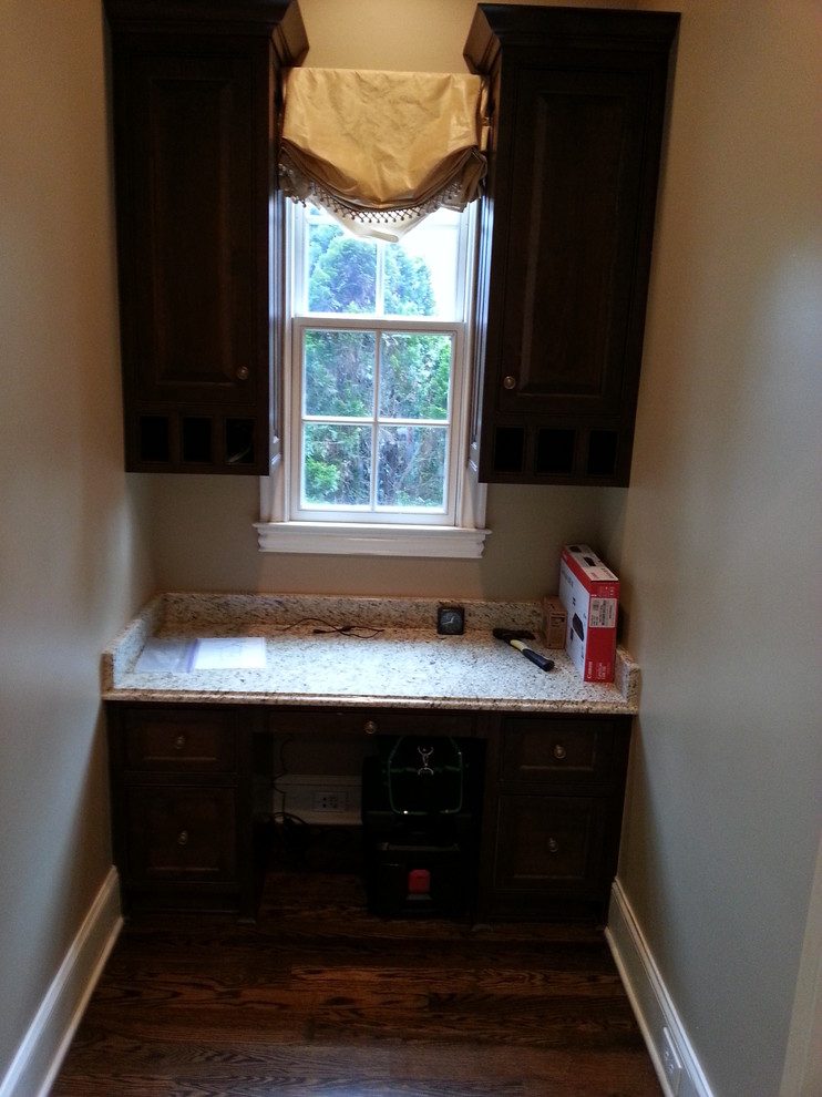 Large traditional study room in Charlotte with beige walls, medium hardwood floors, no fireplace and a built-in desk.