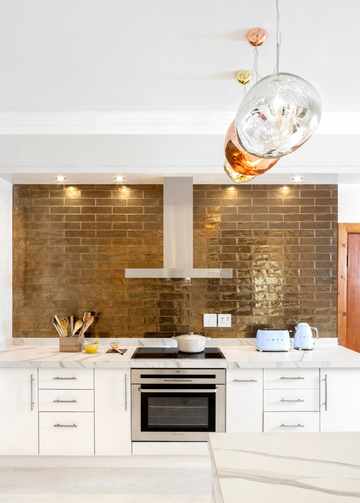 Example of a large transitional eat-in kitchen design with flat-panel cabinets, white cabinets, marble countertops, white countertops and two islands