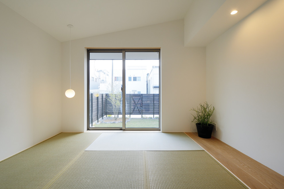 Photo of a small scandi enclosed games room in Other with white walls, tatami flooring, no fireplace, a freestanding tv, green floors, a wallpapered ceiling and wallpapered walls.