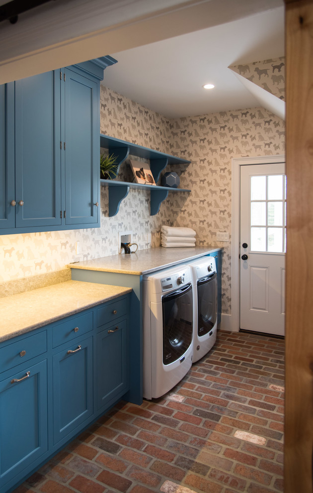 Country laundry room in Philadelphia with an undermount sink, blue cabinets, quartz benchtops, brick floors, a side-by-side washer and dryer and beige benchtop.