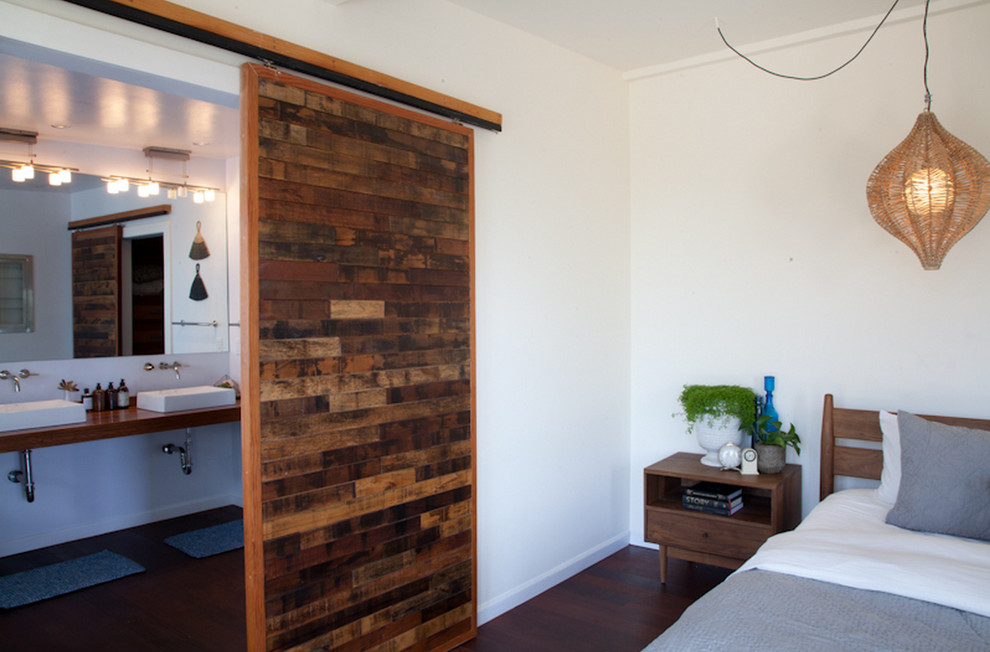 Inspiration for a midcentury master bedroom in Los Angeles with white walls and dark hardwood floors.