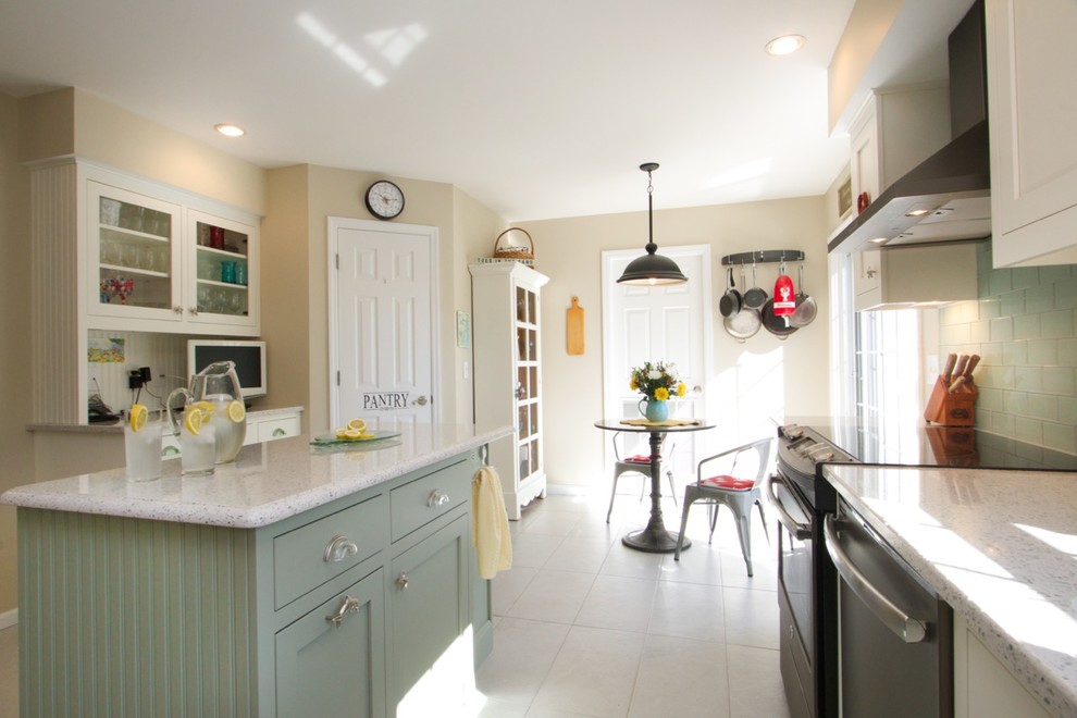 This is an example of a mid-sized beach style l-shaped eat-in kitchen in Orange County with an undermount sink, beaded inset cabinets, white cabinets, granite benchtops, green splashback, ceramic splashback, ceramic floors and with island.