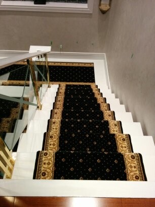 Medium sized victorian carpeted floating glass railing staircase in Toronto with open risers.