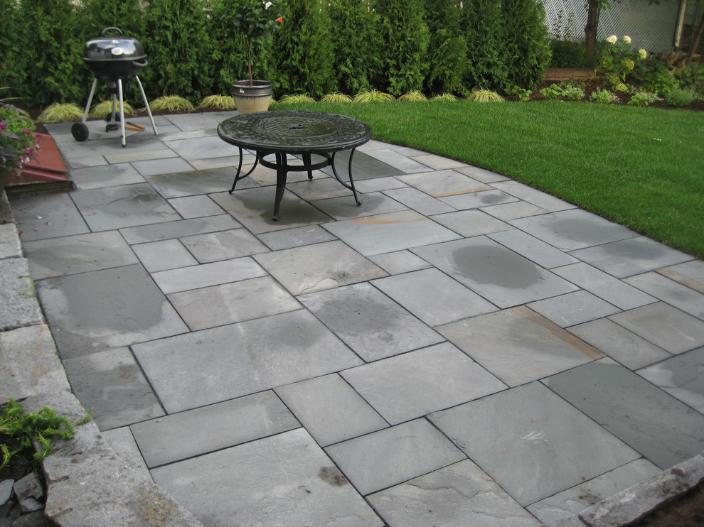 Inspiration for a backyard stone landscaping in Manchester.