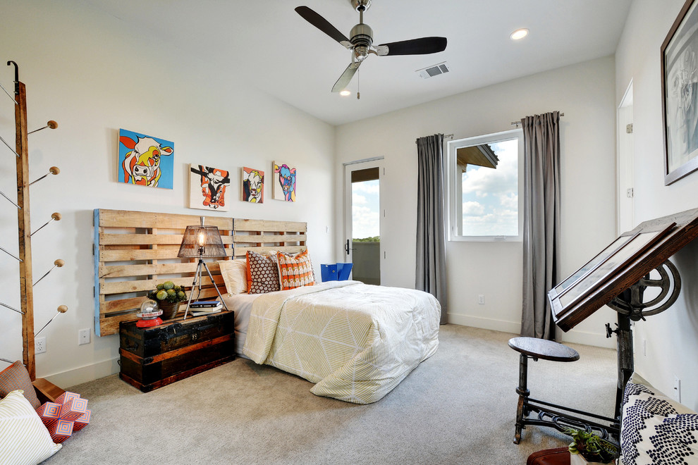Inspiration for a mid-sized industrial guest bedroom in Austin with white walls and carpet.