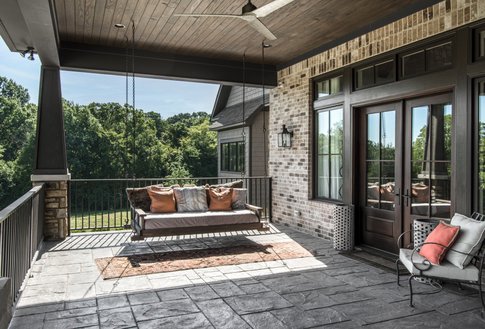 Inspiration for a huge transitional stone porch remodel in Nashville with a roof extension